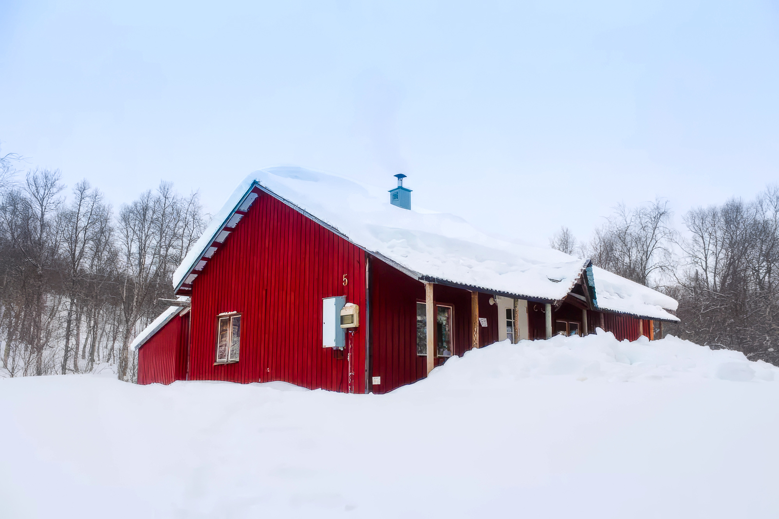 The red mountain cabin under deep snow